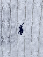 White cable-knit polo shirt fabric with small embroidered pony logo