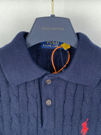 Dark navy knit polo with button placket, ribbed collar, red polo logo