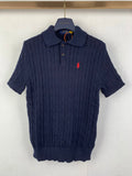 Dark navy cable-knit polo shirt with short sleeves and red polo logo