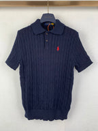Dark navy cable-knit polo shirt with short sleeves and red polo logo