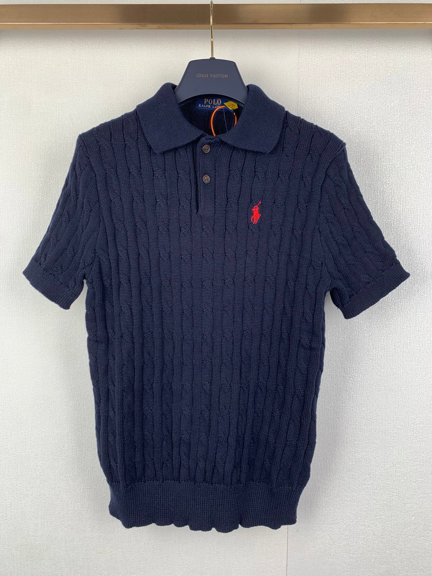 Dark navy cable-knit polo shirt with short sleeves and red polo logo