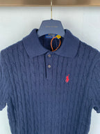 Dark navy cable-knit polo shirt with button placket, red logo, ribbed collar