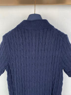 Dark navy cable-knit polo shirt back with ribbed collar and textured knit