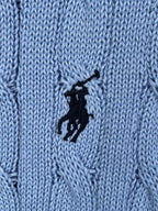 Close-up of light blue cable knit texture with black horse logo patch