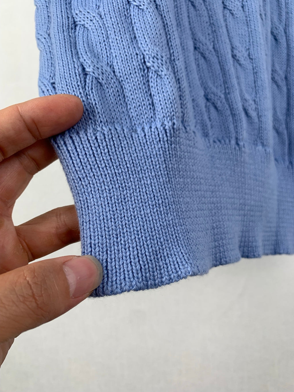 Light blue ribbed knit hem and side seam detail, sweater cuff edge
