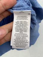 Care label inside light blue knit sweater; Made in Bangladesh