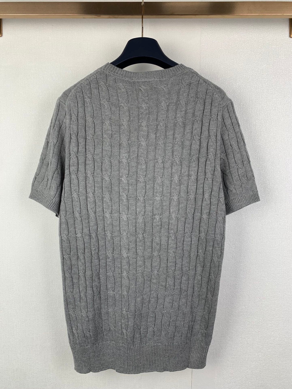 Gray knit polo shirt back view with cable texture and ribbed crew neckline