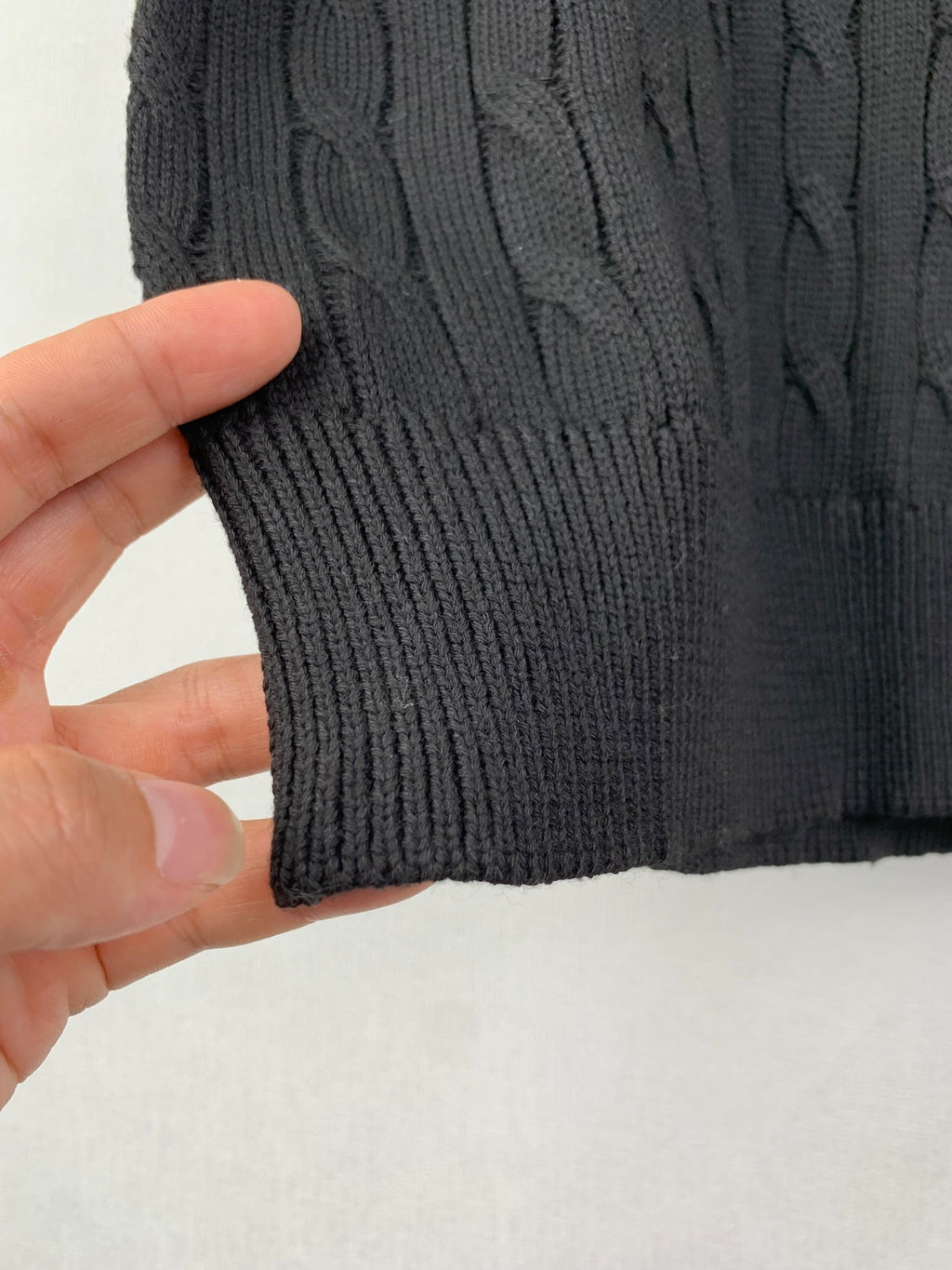 Cable-knit sweater hem and ribbed cuff in dark knit texture