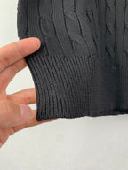 Cable-knit sweater hem and ribbed cuff in dark knit texture