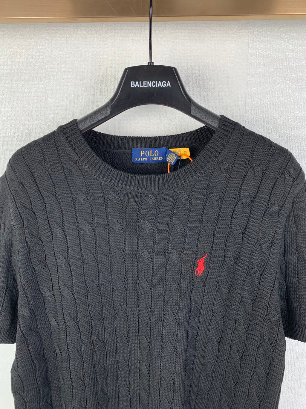Cable-knit sweater neckline with Polo Ralph Lauren label inside crew neck collar