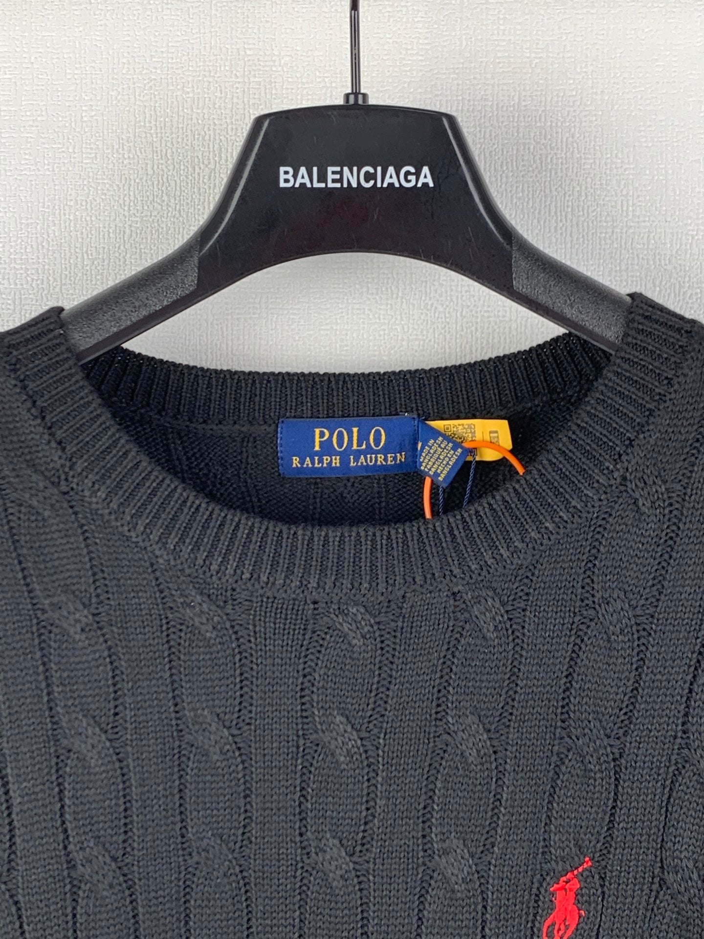 Cable-knit sweater collar with Polo Ralph Lauren label and orange tag