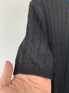 Cable-knit sweater sleeve with ribbed cuff and raised cable texture