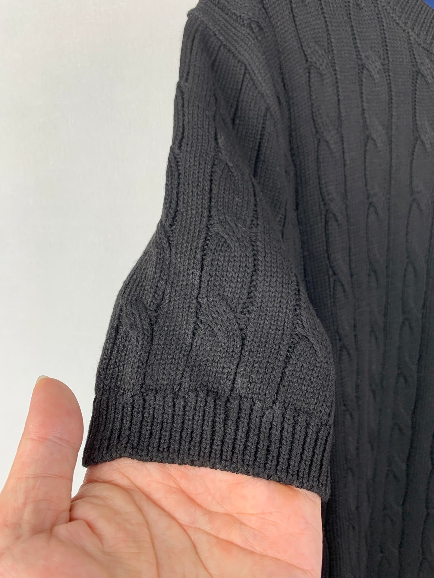 Cable-knit sweater sleeve with ribbed cuff and raised cable texture