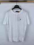 White cable-knit crewneck sweater with small navy polo logo on chest