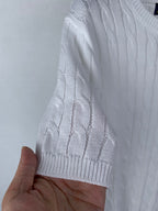 White knit sweater sleeve with ribbed cuff and cable texture
