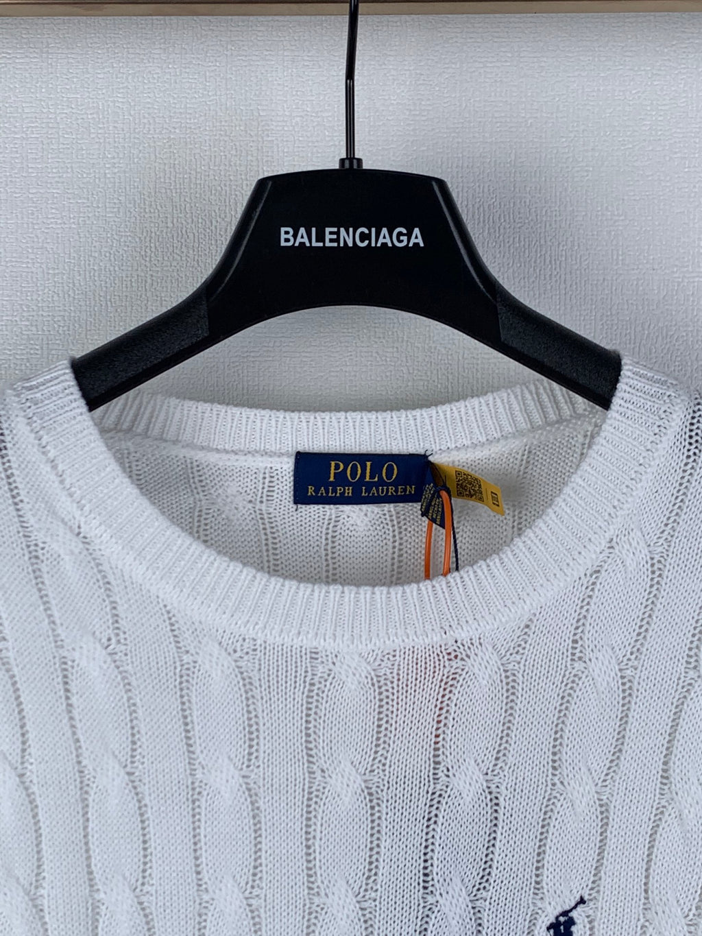 White crewneck sweater with interior brand label and navy polo logo