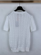 White cable-knit crewneck sweater, back view with ribbed hem and cuffs