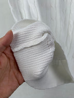White ribbed knit cuff and cable pattern on sweater