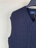 Navy cable-knit sweater vest shoulder with V-neck opening detail