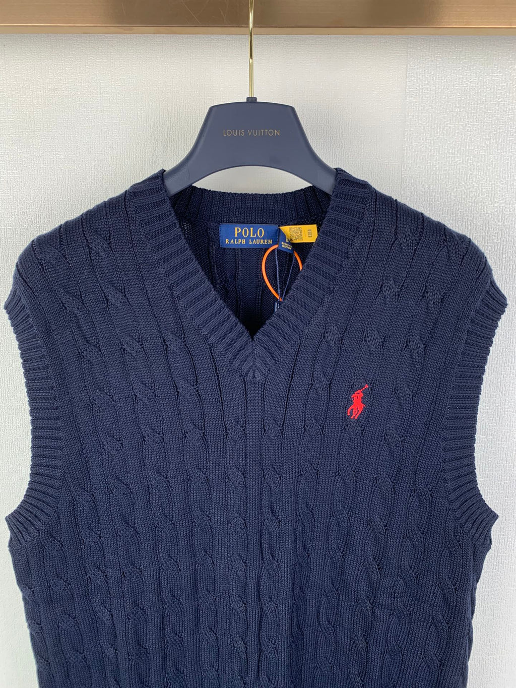 Navy cable-knit sweater vest with V-neck and red polo logo