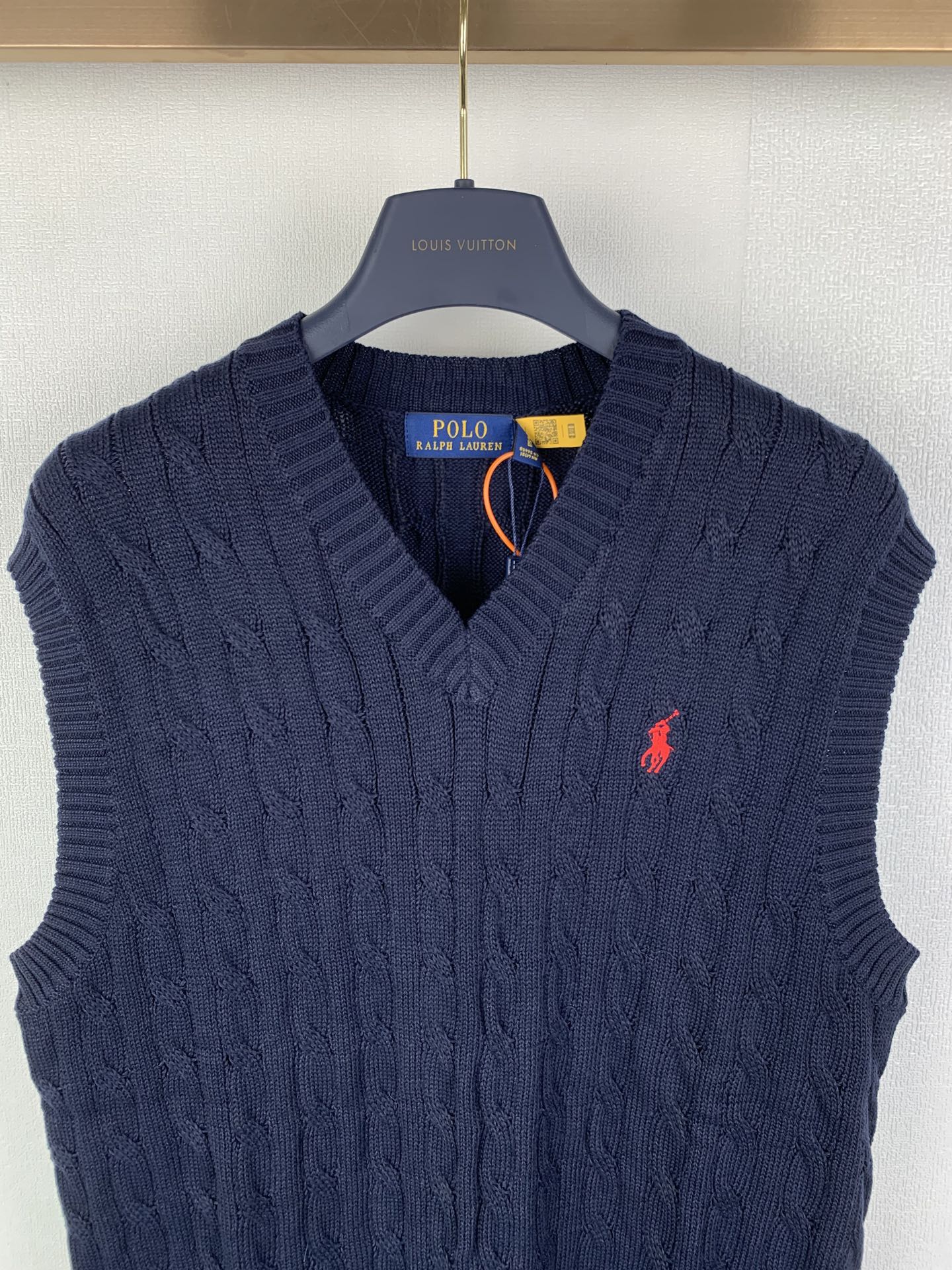 Navy cable-knit sweater vest with V-neck and red polo logo