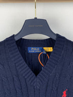 Navy cable-knit sweater vest with V-neck, red polo logo, and neck tag