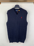 Navy cable-knit sweater vest with V-neck and small red logo on chest