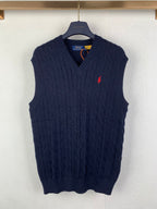 Navy cable-knit sweater vest with V-neck and small red logo on chest