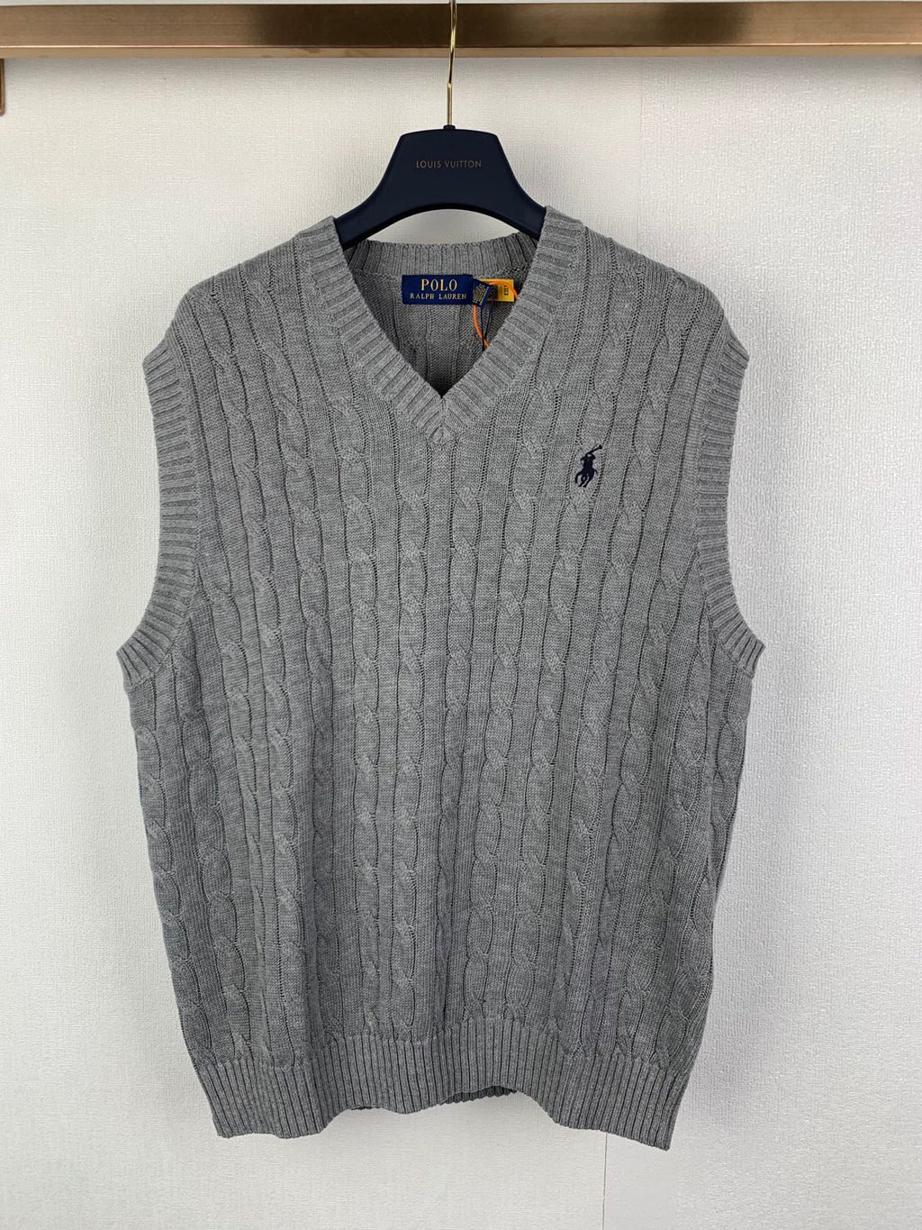 Gray knit sleeveless sweater vest with V-neck and small Polo logo on chest