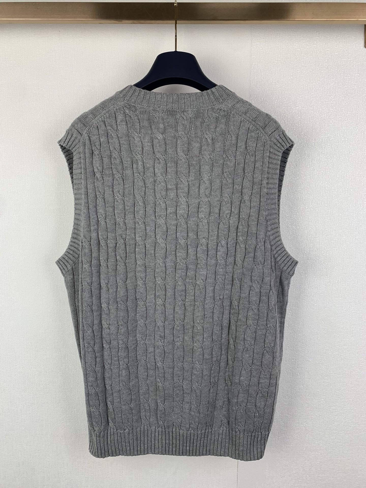 Gray knit sleeveless sweater vest, cable texture, V-neck and ribbed hem