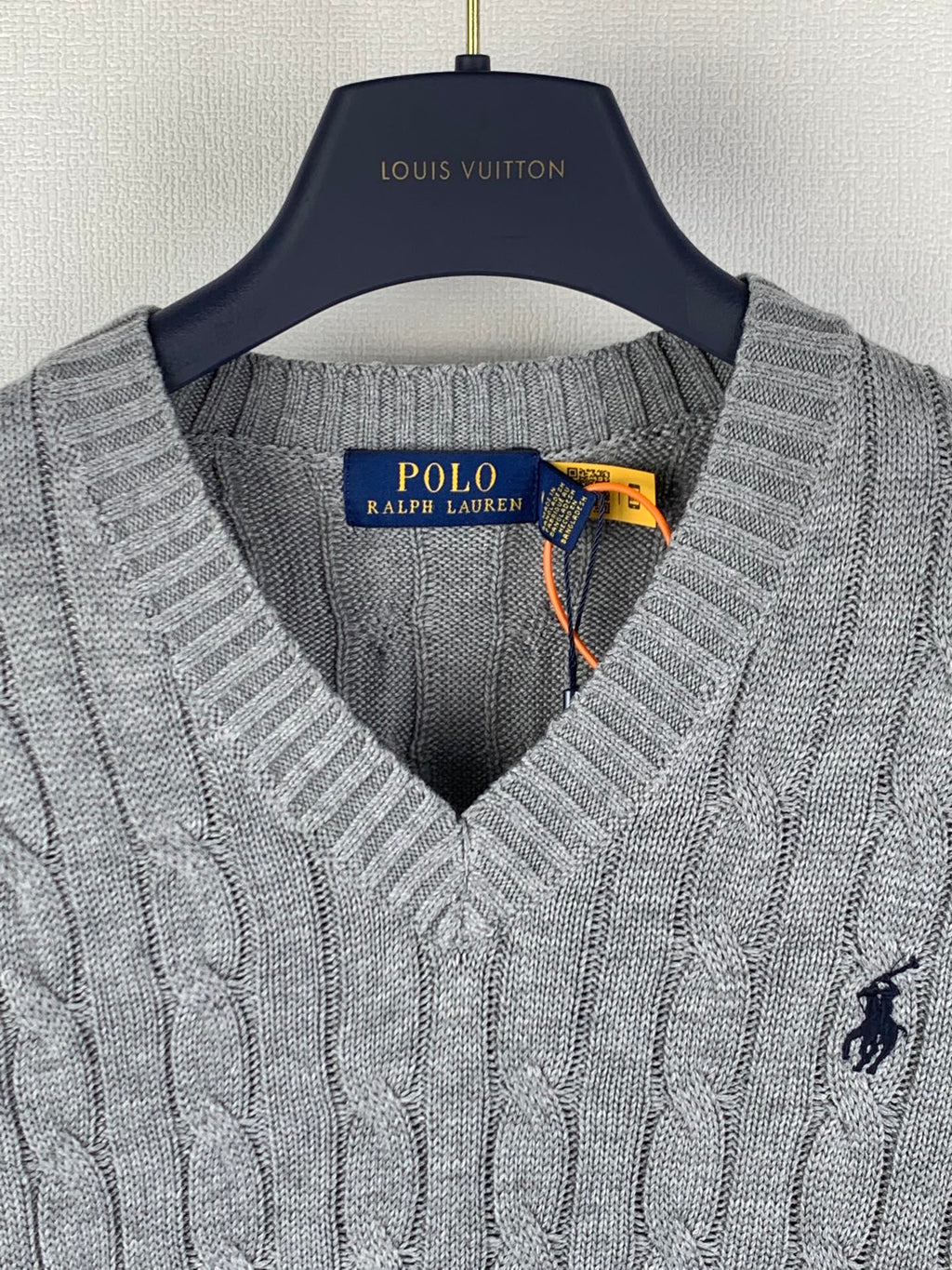 Gray knit sleeveless sweater vest close-up of V-neck and Polo logo