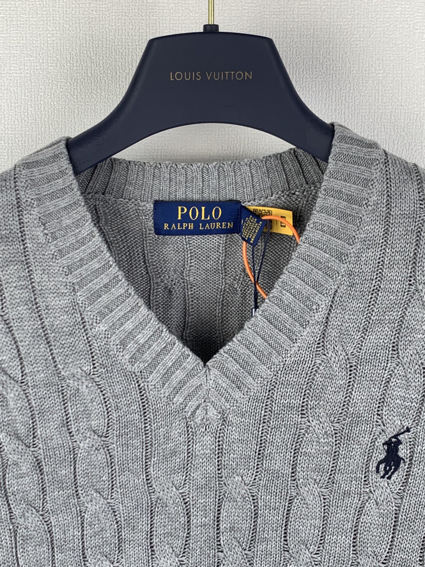 Gray knit sleeveless sweater vest close-up of V-neck and Polo logo
