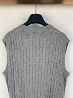 Gray cable-knit sleeveless sweater vest back view with ribbed neckline and hem