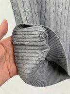 Gray knit ribbed cuff detail on sleeveless sweater vest, folded edge view