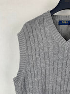 Gray cable-knit sleeveless sweater vest side view with V-neck ribbed trim