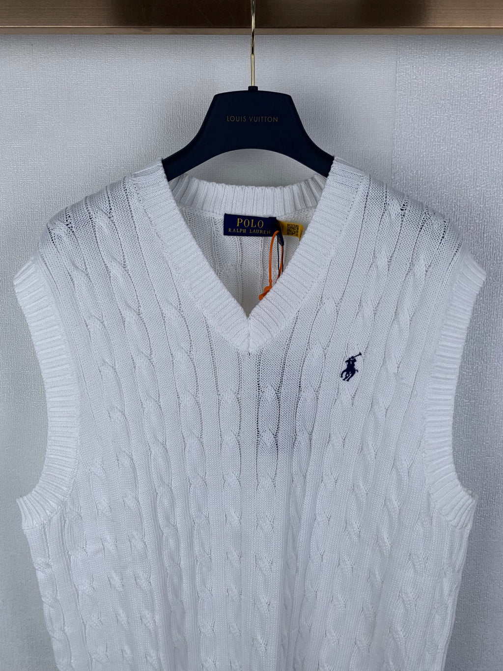White sleeveless cable-knit sweater vest with V-neck and Polo logo
