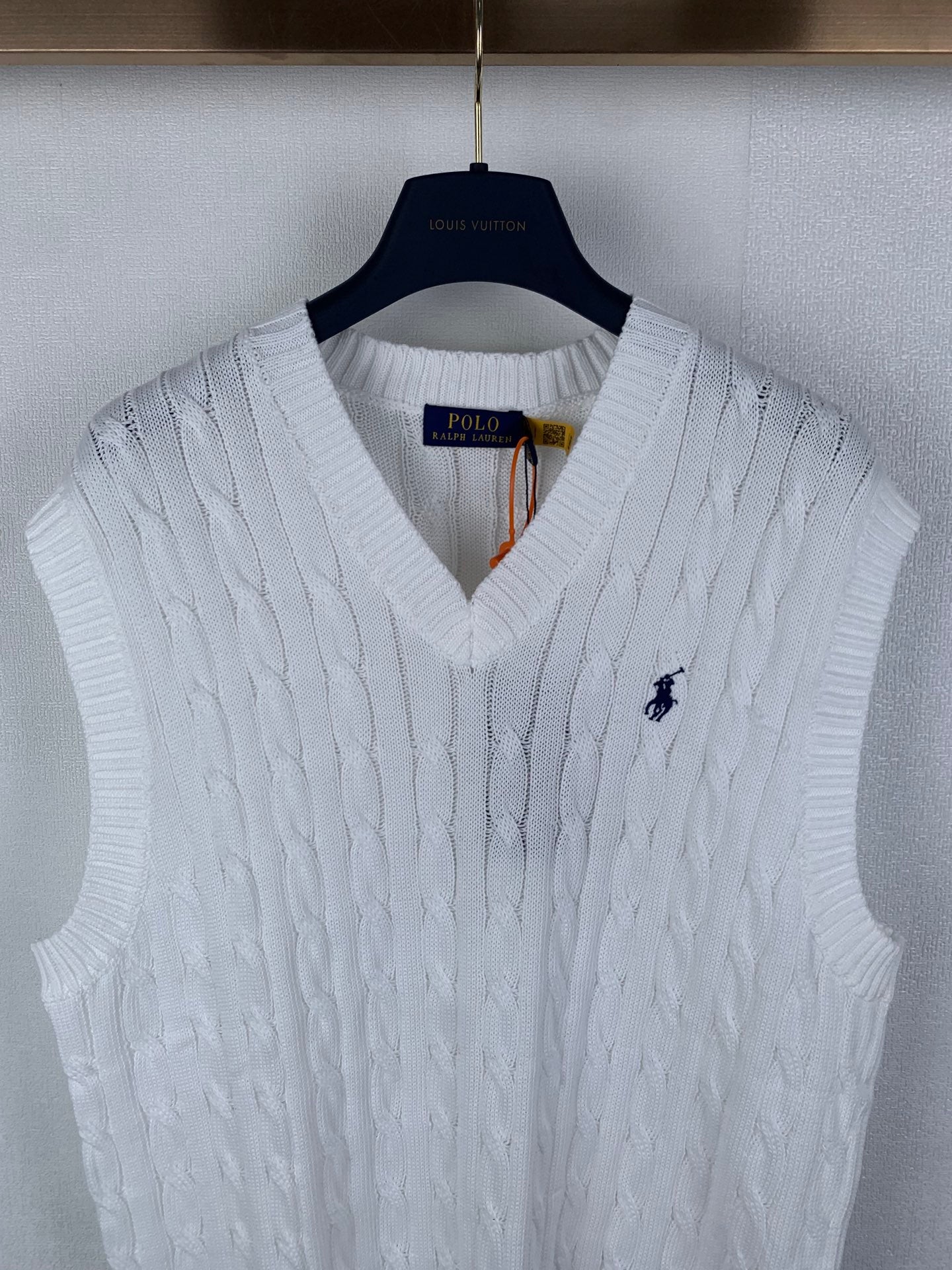 White sleeveless cable-knit sweater vest with V-neck and Polo logo
