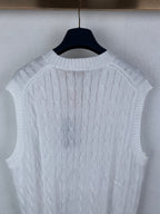 White sleeveless cable-knit sweater vest showing knit texture on back