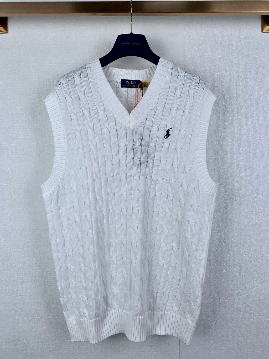 White cable-knit sweater vest with V-neck and small Polo logo on chest
