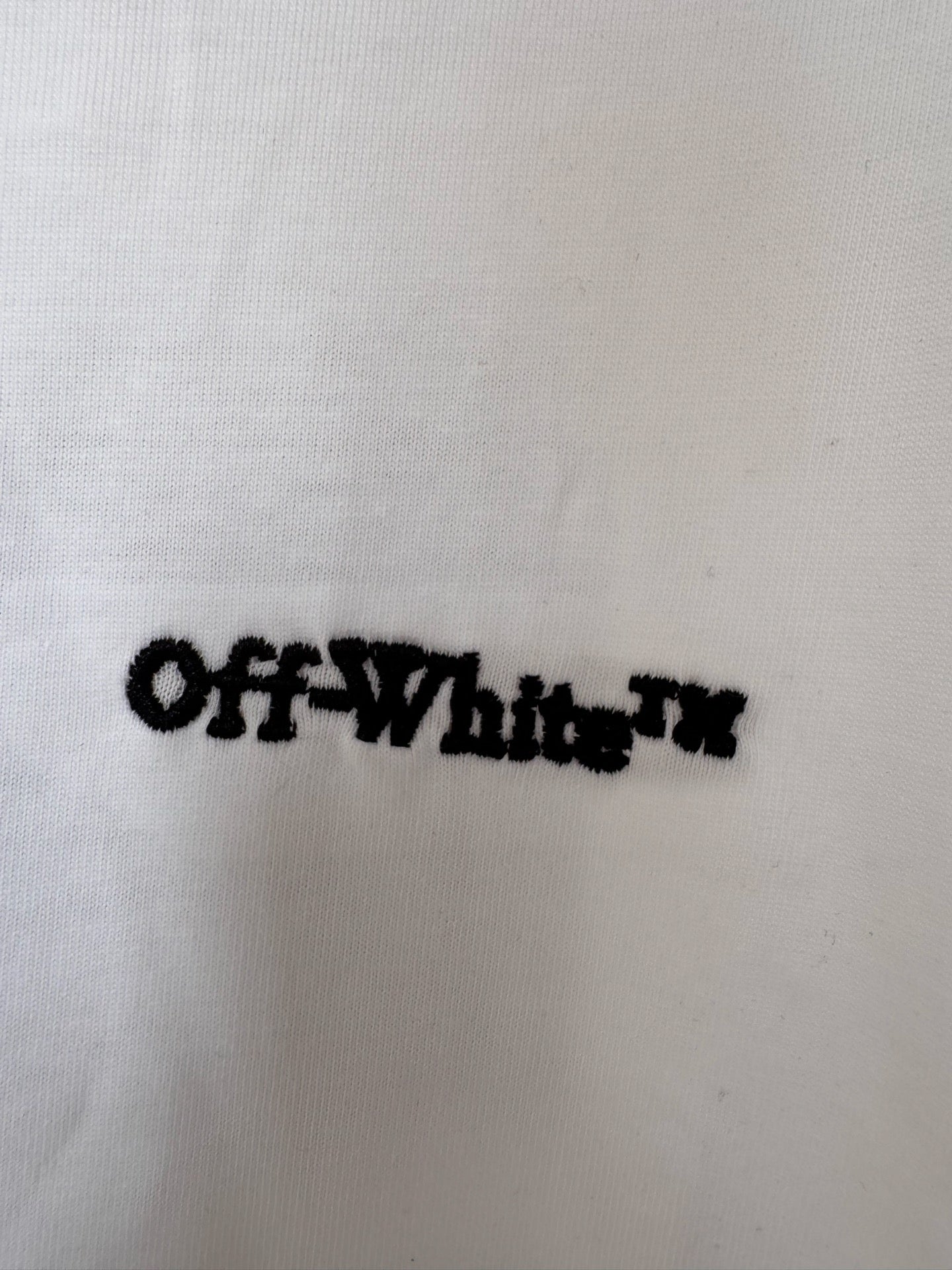 OffWhite™ wordmark on off-white T-shirt fabric