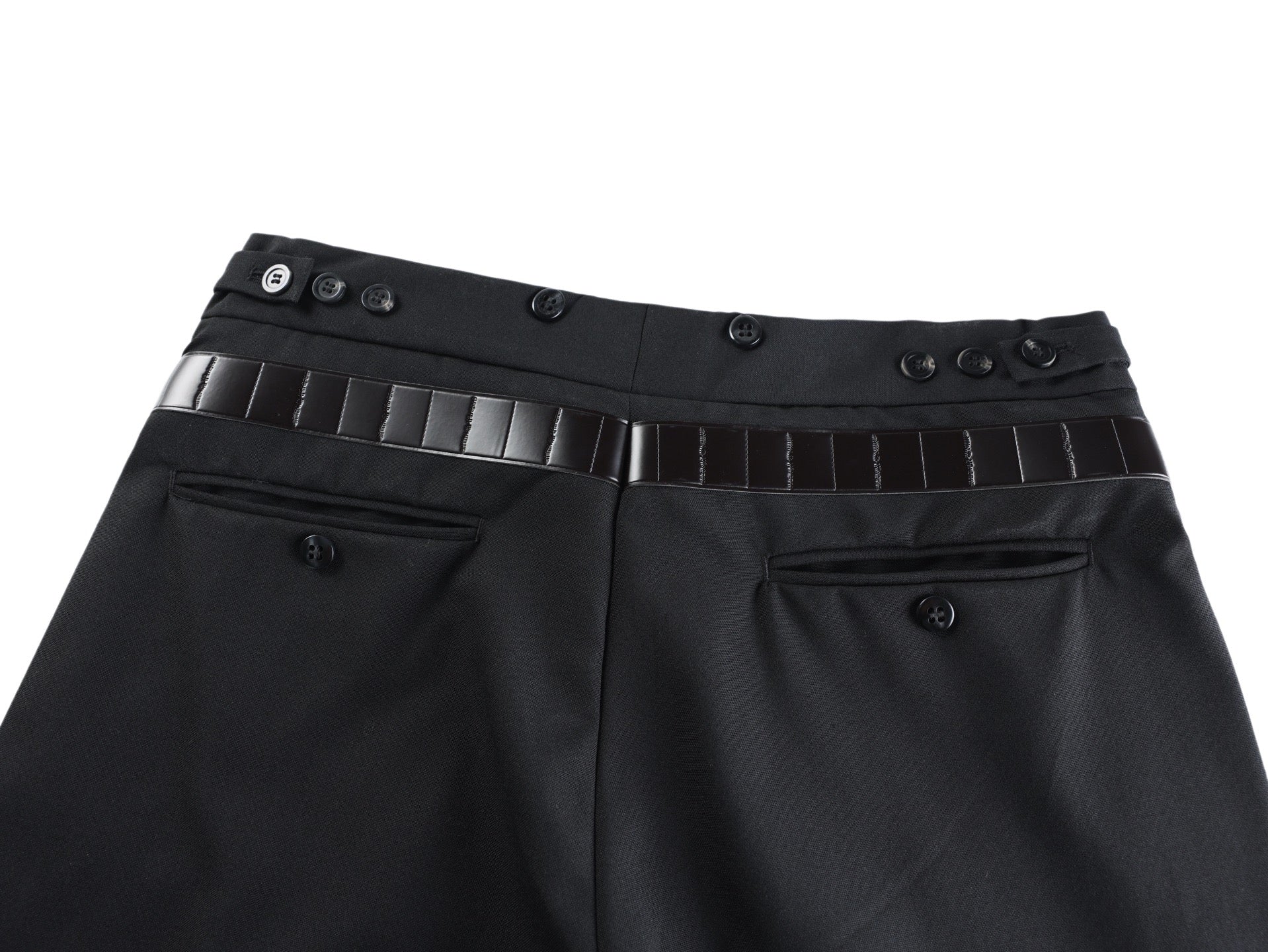 Black pants front with belt strap, metal buckle, and buttoned waistband