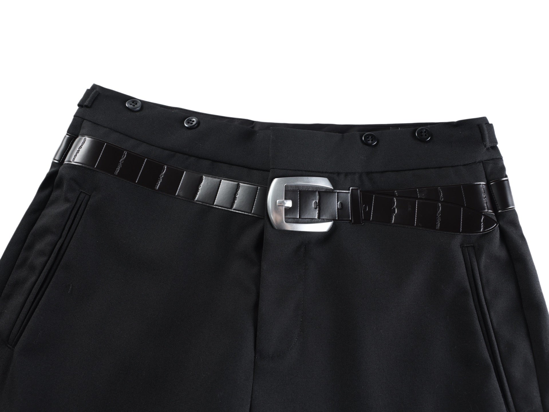 Black pants waistband with belt strap, metal buckle, and decorative belt loops