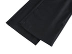Black pants leg with visible inner seam and folded hem