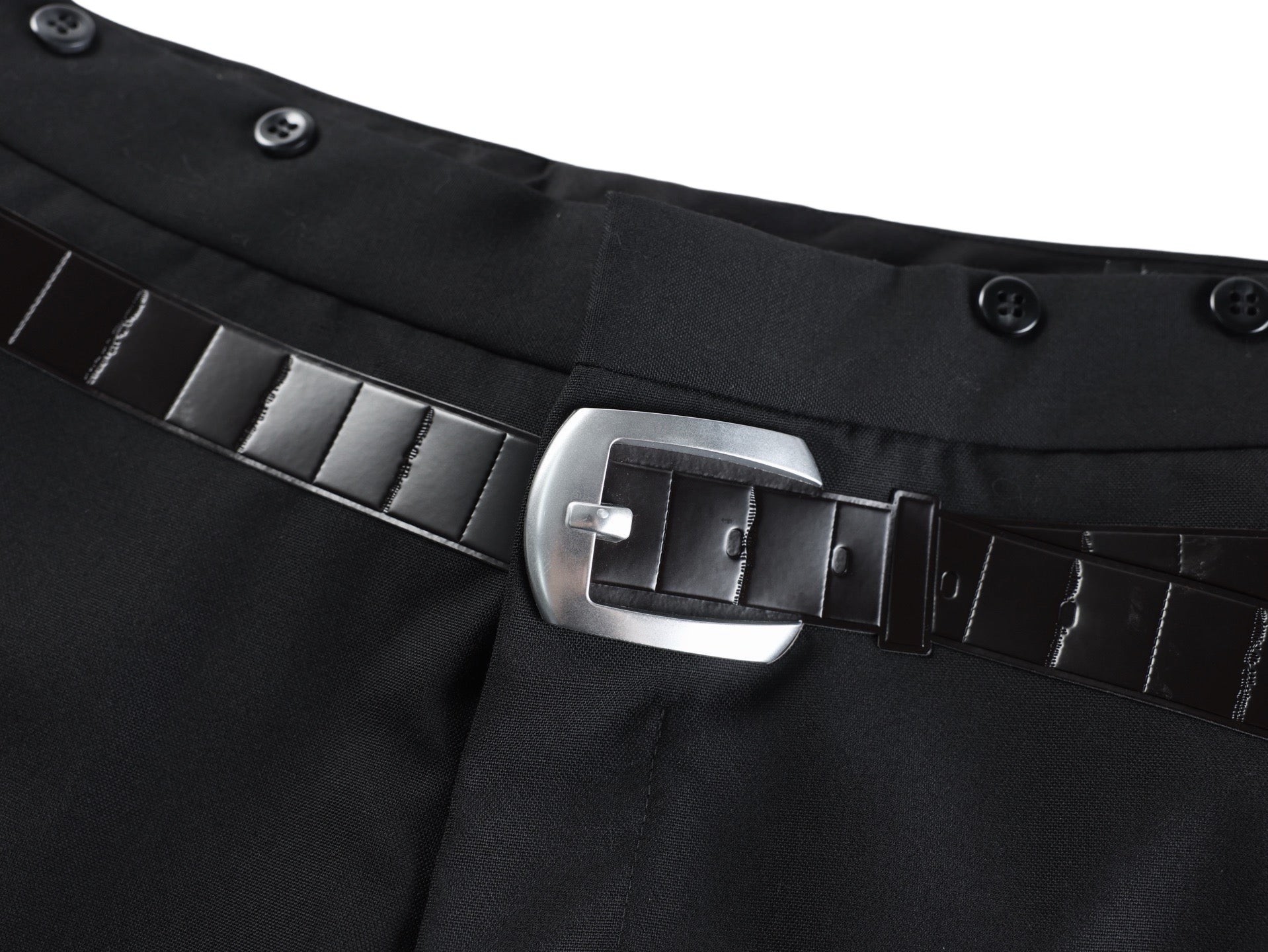 Black pants belt detail with metal buckle and wide stitched belt strap