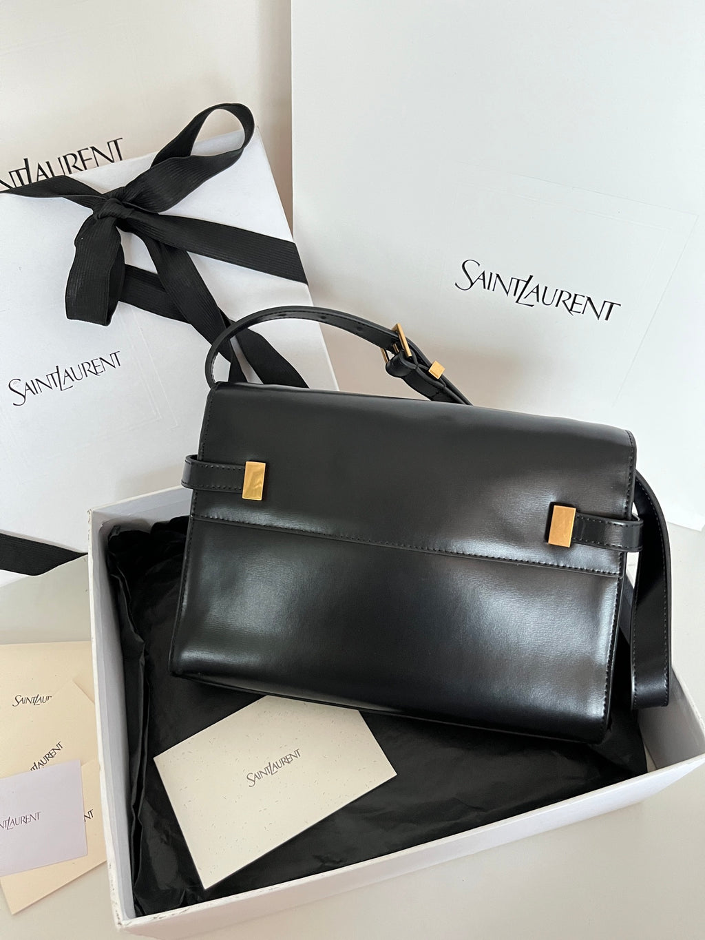 Black YSL handbag with gold-tone hardware, flap front and shoulder strap