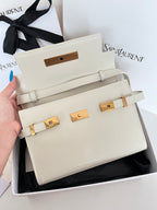 Cream leather handbag front with gold-tone belt hardware and top handle straps