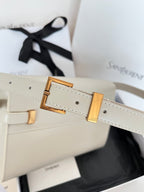 Cream leather handbag strap with gold buckle and rectangular hardware detail