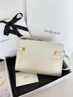 Cream leather handbag with gold clasp and curved shoulder strap, front view