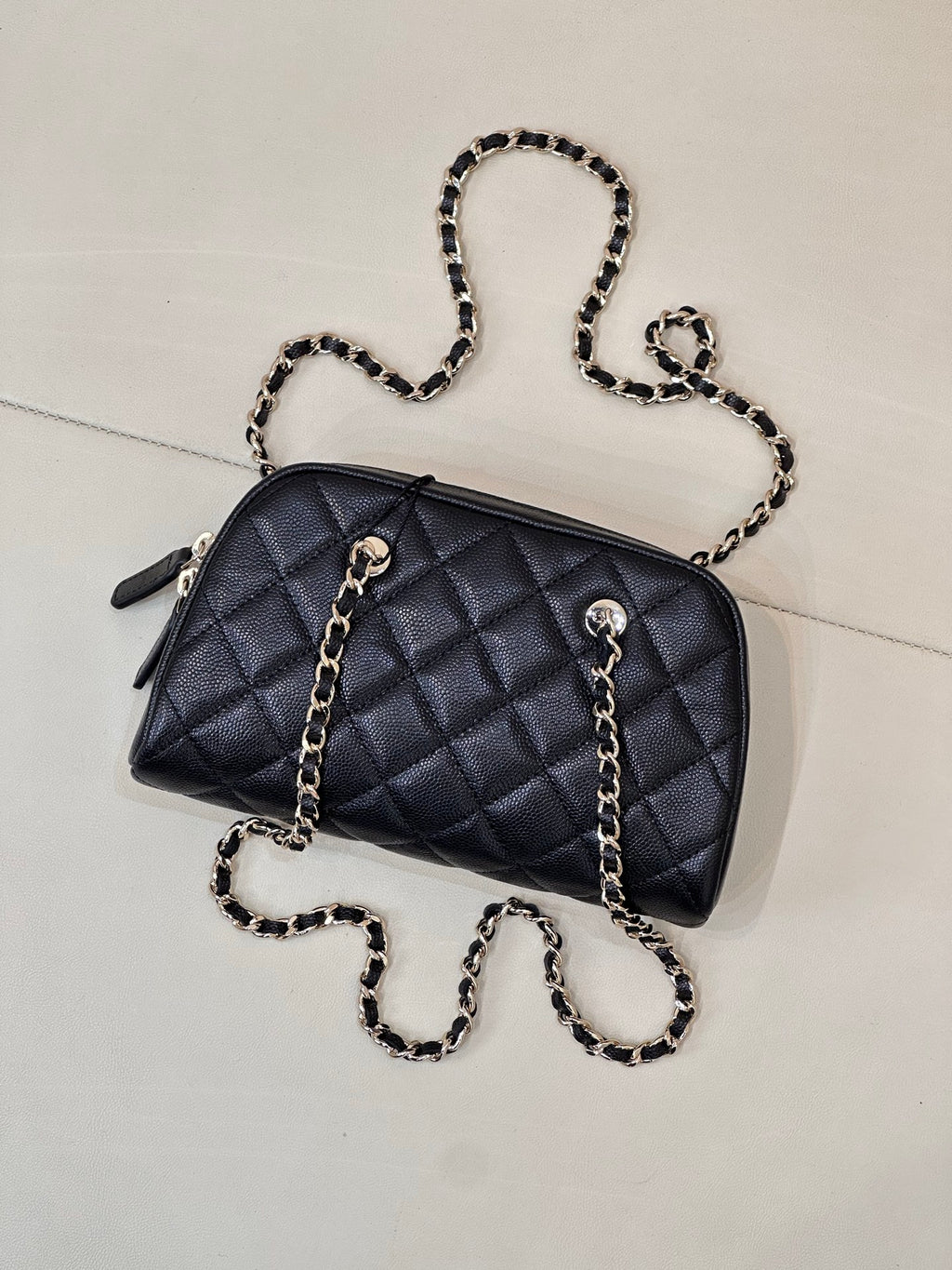 Chanel quilted bag in dark blue with chain strap and zipper opening on top
