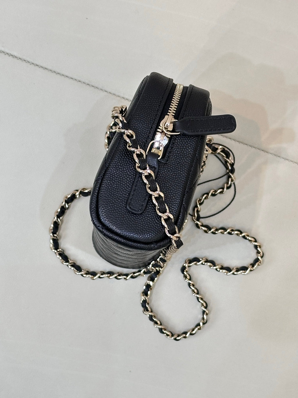 Chanel small quilted bag in dark blue with black strap detail and gold-tone chain
